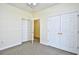 Bedroom with carpet, white doors, and ample closet space at 213 Wando River Rd. # 11-G, Myrtle Beach, SC 29579