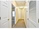 Hallway features neutral carpet and white doors with gold hardware at 213 Wando River Rd. # 11-G, Myrtle Beach, SC 29579