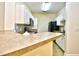 Well-lit kitchen featuring white cabinets, stainless steel appliances, and breakfast bar at 213 Wando River Rd. # 11-G, Myrtle Beach, SC 29579