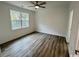 Spacious bedroom with wood-look floors and a window at 2509 Ye Olde Kings Hwy., North Myrtle Beach, SC 29582