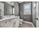 Powder room with a white vanity, toilet and wood-look flooring at 2560 Ellerbe Circle, Myrtle Beach, SC 29588