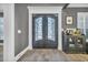 Elegant entryway with double doors and a vintage-style console table at 2560 Ellerbe Circle, Myrtle Beach, SC 29588