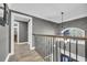 Elegant hallway with hardwood floors and wrought iron railing at 2560 Ellerbe Circle, Myrtle Beach, SC 29588