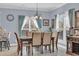 Elegant dining area with a wood table, and neutral-toned upholstered chairs at 274 Avenue Of The Palms, Myrtle Beach, SC 29579