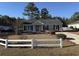 Cute ranch home with a landscaped lawn and white picket fence at 2958 Mary Hines Ln., Georgetown, SC 29440