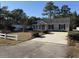 Tan house with a white fence and driveway at 2958 Mary Hines Ln., Georgetown, SC 29440