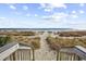 Sandy beach access path with wooden gate at 3000 Ocean Blvd. N # 1905, Myrtle Beach, SC 29577