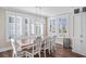 Bright dining room with white chairs and large windows at 304 Spartina Ct., North Myrtle Beach, SC 29582