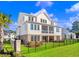 Two-story house with screened porch, brick and white siding, and a fenced backyard at 304 Spartina Ct., North Myrtle Beach, SC 29582