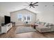 Spacious living room with vaulted ceiling, L-shaped sofa, and large TV at 304 Spartina Ct., North Myrtle Beach, SC 29582