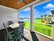 Screened porch with lake and golf course views, table and chairs at 304 Spartina Ct., North Myrtle Beach, SC 29582