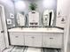 Double vanity bathroom with white cabinets and gray walls at 340 N Reindeer Rd., Surfside Beach, SC 29575