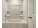 Bathroom with shower/tub combo and built-in shelves at 340 N Reindeer Rd., Surfside Beach, SC 29575