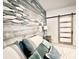 Bedroom with wood accent wall and sliding barn door at 340 N Reindeer Rd., Surfside Beach, SC 29575