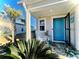 Front porch with rocking chair and blue front door at 340 N Reindeer Rd., Surfside Beach, SC 29575