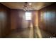 Simple bedroom with wood paneling and ceiling fan at 3757 Methodist Rehobeth Rd., Galivants Ferry, SC 29544