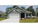 Gray siding, white garage door, and manicured lawn enhance this charming home's curb appeal at 398 Glacier Way, Conway, SC 29526