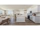 Modern kitchen with white cabinetry, island, and ample natural light at 398 Glacier Way, Conway, SC 29526