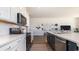 White shaker cabinets, quartz countertops, and stainless steel appliances in a modern kitchen at 398 Glacier Way, Conway, SC 29526