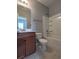 Clean bathroom with a tub, toilet, and vanity with wood cabinets at 4085 Alvina Way, Myrtle Beach, SC 29579