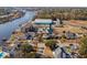 Aerial view of waterfront home with circular design at 4552 River Rd., Little River, SC 29566