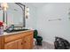 Small bathroom with dark green vanity and toilet at 4552 River Rd., Little River, SC 29566