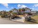 Two-story house with circular design, brick exterior, and palm trees at 4552 River Rd., Little River, SC 29566