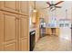 Kitchen features light wood cabinets, tile floor and stainless steel appliances at 4552 River Rd., Little River, SC 29566