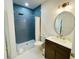 Bathroom with a walk-in shower, dark vanity, and blue tile at 4881 Dahlia Ct. # 101, Myrtle Beach, SC 29577