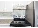 Stainless steel stove and range hood with white cabinets at 500 Fairway Village Dr. # 7-F, Myrtle Beach, SC 29588