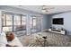 Living room with wood-look floors and sliding glass doors to patio at 500 Fairway Village Dr. # 7-F, Myrtle Beach, SC 29588