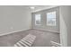 Spacious bedroom with two windows, ceiling fan and gray carpeting at 5023 Sweet Birch Lane, Conway, SC 29526