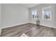 Simple bedroom with hardwood floors and two windows at 5023 Sweet Birch Lane, Conway, SC 29526