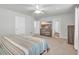 Comfortable bedroom with a striped comforter, dresser, and large TV at 5023 Sweet Birch Lane, Conway, SC 29526