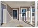 Front door entry to the house with a covered porch and white columns at 5023 Sweet Birch Lane, Conway, SC 29526