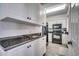 Kitchen with white cabinets, granite counters, and black appliances at 5310 N Ocean Blvd. N # 207, Myrtle Beach, SC 29577