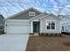 New construction home with gray siding, white garage door, and teal front door at 5439 Shelly Lynn Dr., Myrtle Beach, SC 29579