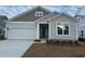 New construction home with gray siding, white garage door, and teal front door at 5439 Shelly Lynn Dr., Myrtle Beach, SC 29579