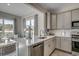 Kitchen island with seating, stainless steel appliances, and views to the backyard at 5439 Shelly Lynn Dr., Myrtle Beach, SC 29579