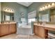 Large bathroom with double vanities and a corner tub at 58 Long Creek Dr., Murrells Inlet, SC 29576