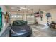 Spacious garage with Tesla and ample storage shelving at 5808 Bridlewood Rd., North Myrtle Beach, SC 29582