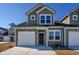 Two-story townhome with gray siding, white garage door, and landscaping at 592 Sea Sparrow St., Myrtle Beach, SC 29588