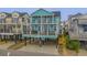 Two-story teal home with multiple balconies and ocean views at 6001 - E8 S Kings Hwy., Myrtle Beach, SC 29575