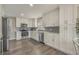 Modern white kitchen with stainless steel appliances and gray tile backsplash at 6001 - E8 S Kings Hwy., Myrtle Beach, SC 29575