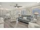 Spacious living room with gray couch and striped armchairs at 6001 - E8 S Kings Hwy., Myrtle Beach, SC 29575