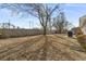 Fenced backyard with mature tree and grill at 603 Plantation Dr., Surfside Beach, SC 29575