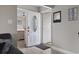 Bright entryway with white door, gray walls, and a glimpse into the living room at 603 Plantation Dr., Surfside Beach, SC 29575