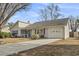 One-story house with gray siding, a driveway, and a well-maintained lawn at 603 Plantation Dr., Surfside Beach, SC 29575