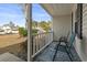 Relaxing front porch with two teal chairs and a patterned rug at 603 Plantation Dr., Surfside Beach, SC 29575