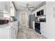 Modern kitchen with white cabinets and stainless steel appliances at 603 Plantation Dr., Surfside Beach, SC 29575